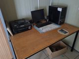 a desk with two computers and a printer on it