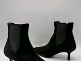 pair of black sued ankle boots on a white background