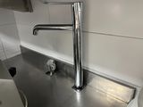 a sink with a faucet in the middle of it