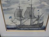 painting of a sailing ship in a frame on a table