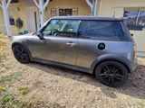 une petite voiture argentée garée devant une maison