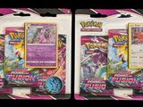 two packs of pokemon trading cards on a black background