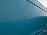 a blue bus that is driving down the street