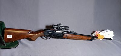 a toy gun that is on a table next to a hat
