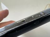 a hand that is holding a cell phone with a sticker on it