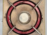 an overhead view of a stove with a red ring on top of it