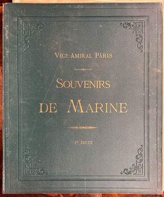 an old book sitting on top of a table next to a wooden table