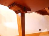 a wooden table with a wooden top on a hard wood floor