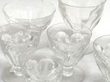 six wine glasses sitting next to each other on a table