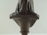 bronze bust of a woman with a veil on it ' s head