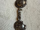 a close up of a metal bracelet with a horse on it