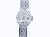 a close up of a wrist watch on a white surface