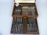a wooden box with silverware in it on a table