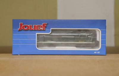 a box with a toy train in it on a table