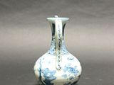 a small blue and white vase sitting on a table