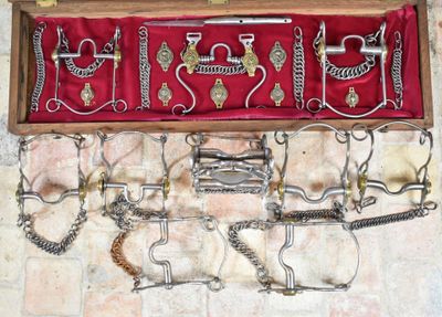 a wooden box with a bunch of metal objects in it