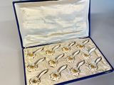 a blue case with gold fish in it on a white table