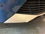 a close up of the front of a blue car