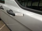 a white car with a sticker on the side of it ' s door