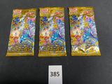 three packs of pokemon trading cards on a table