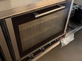 stainless steel counter top with oven and microwave on it