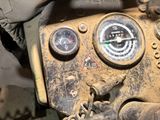 a close up of a gauge on a vehicle ' s dashboard