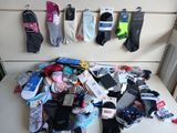 many pairs of socks hanging on the wall next to each other