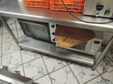 a microwave that is sitting on a table in the kitchen