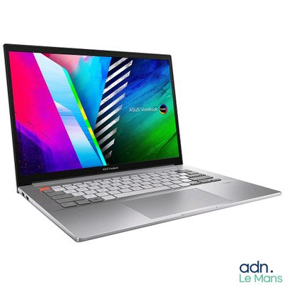 the laptop is open on a white surface with a colorful background