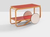 a red table with wheels and a wooden shelf on top