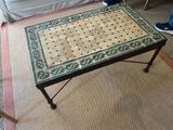 a table that has a tile on it in a living room