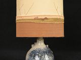 a lamp that is on a table with a book on it