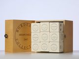 a wooden box filled with white chocolates sitting on top of a table