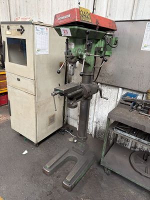 a machine that is sitting next to a refrigerator