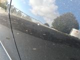 a reflection of a car on the side of the road