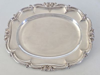 a silver plate with a decorative design on it