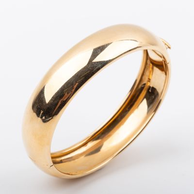 gros plan d'une bague en or sur fond blanc