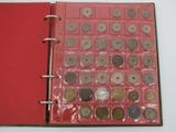 a red book with a bunch of coins inside of it