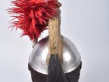 a silver helmet with a red pom pom on it