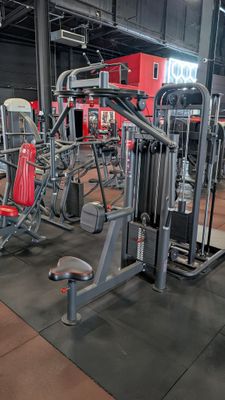 a gym room with a lot of equipment in it