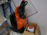 a small orange and black electric forklift in a room