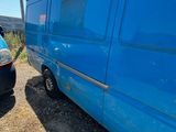 a blue van that is parked next to a blue van