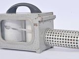 a small metal grater with a handle on a white background