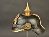 a black helmet with a gold decoration on it