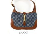 the gucci bag is blue and brown with a brown handle