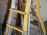 a yellow ladder that is leaning against a wall