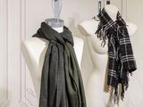 two scarves hanging on a mannequin in a room