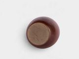 a close up of a brown object on a white surface
