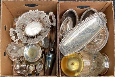two boxes that have silverware in them on a table