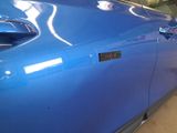 a close up of a car door with a sticker on it